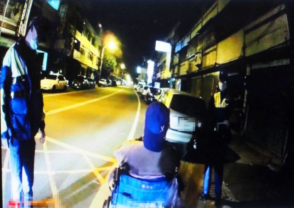 輪椅老人不肯跟工作人員回去，不斷推輪椅前行，員警一直勸說他