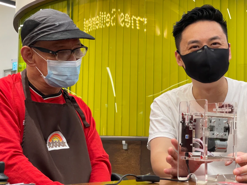 李崇山Jason（右）發明過可摺合的環保重用飲管，他不少產品也是與聖雅各福群會的庇護工場合作生產，更發明出不少小工具幫助殘疾人士工作，實現殘而不廢的理念。
